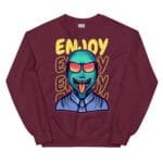 A colorful unisex sweatshirt featuring a vibrant alien wearing sunglasses with a playful expression, set against a bold yellow "ENJOY" text design