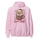 Adorable Pomeranian puppy tucked into a hot chocolate mug with Warm and Fluffy text on a unisex hoodie gift for dog moms and dads
