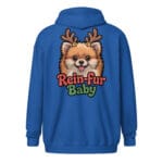 Cheerful Pomeranian puppy wearing reindeer antlers with Rein-fur Baby text on a zip hoodie for dog moms and dads