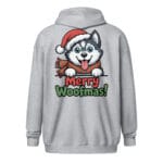 Cheerful Siberian Husky puppy wearing a Santa hat and scarf with Merry Woofmas text on a unique back print zip hoodie for dog moms and dads